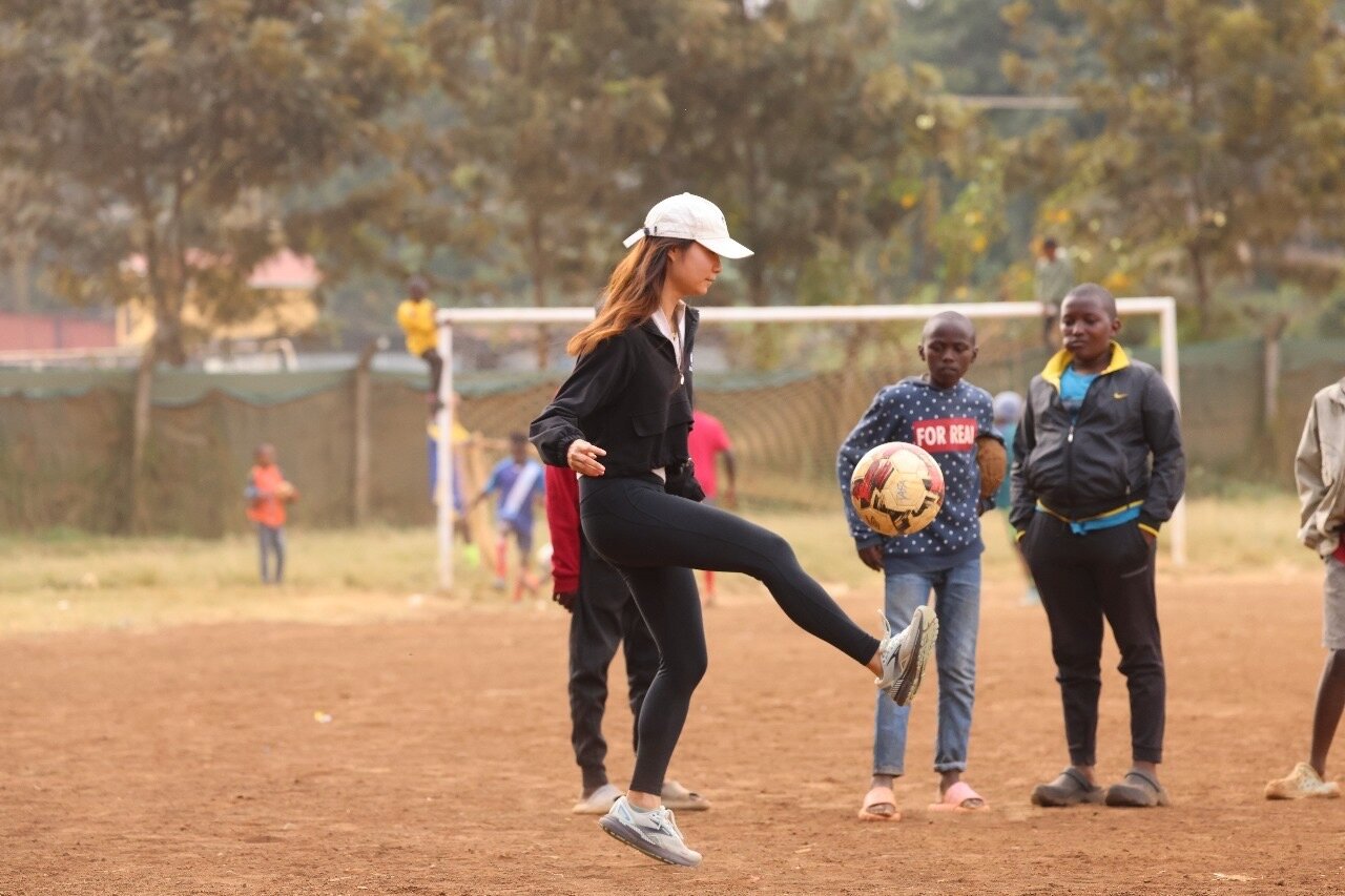 Karis playing football with TAFA youth in Kenya