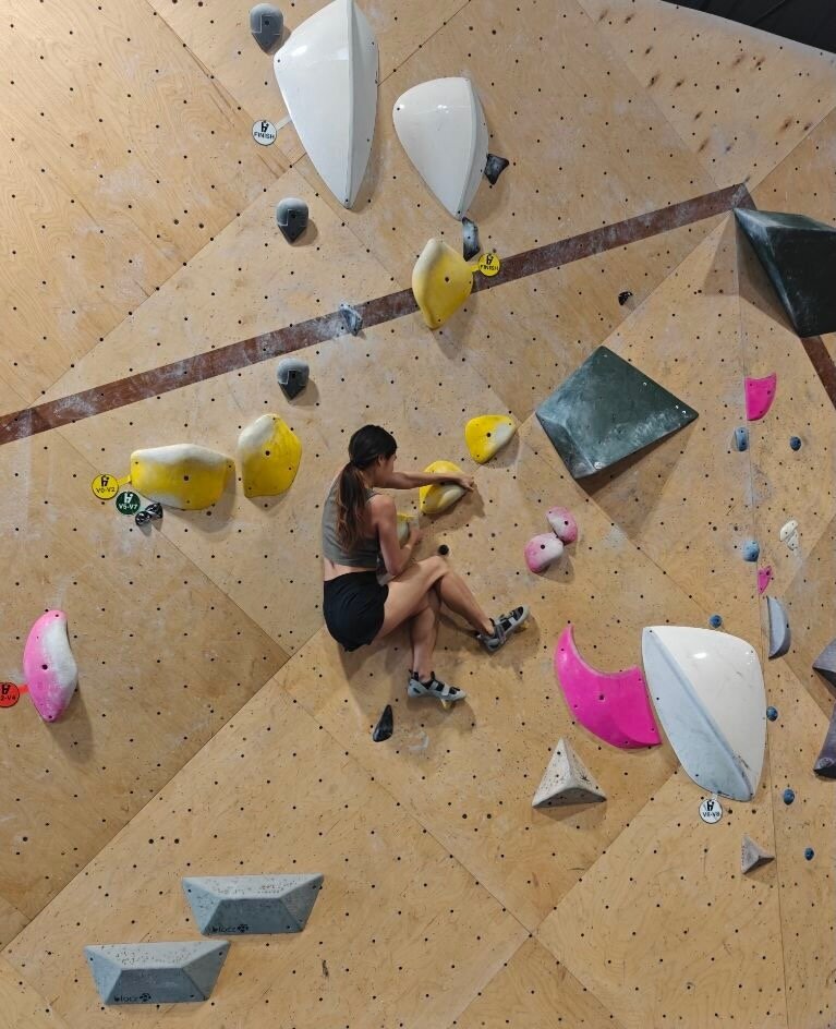Karis bouldering on a climbing wall